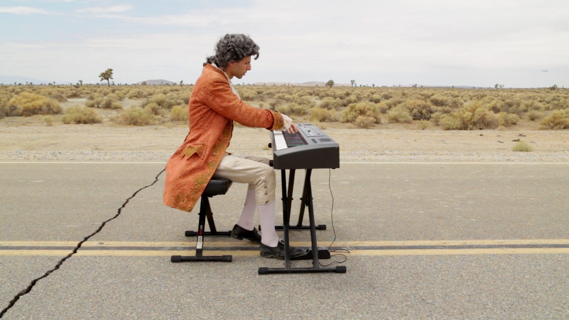 mozart plays piano on a desert road